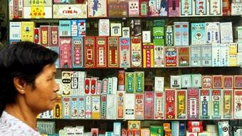 A pedestrian walks past a Chinese pharmacy window display stacked with Chinese medicine packages in Hong Kong (Photo: AP Photo/Anat Givon)